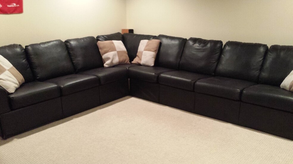 Spacious lower-level den can fit a theater sectional couch (den is unfurnished) - 519 N Payne St