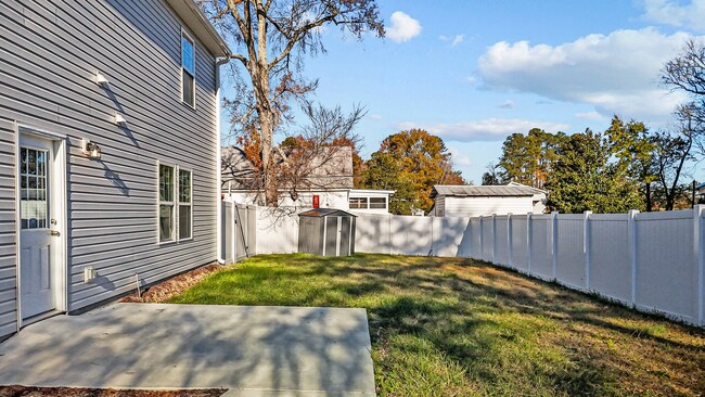 View of backyard; small shed included on property - 105 E Carolina Ave