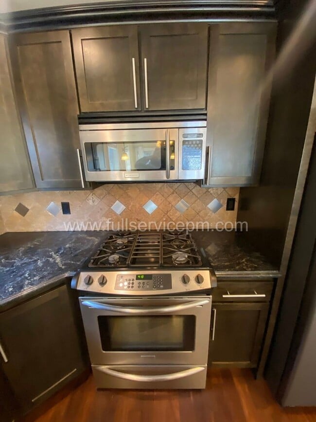 Building Photo - Spacious townhome with private backyard, garage parking, multiple decks, and a dedicated home off...