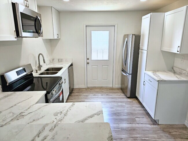 Building Photo - fully renovated 2-bedroom, 1-bathroom home with bonus guest room or office and oversized fenced yard