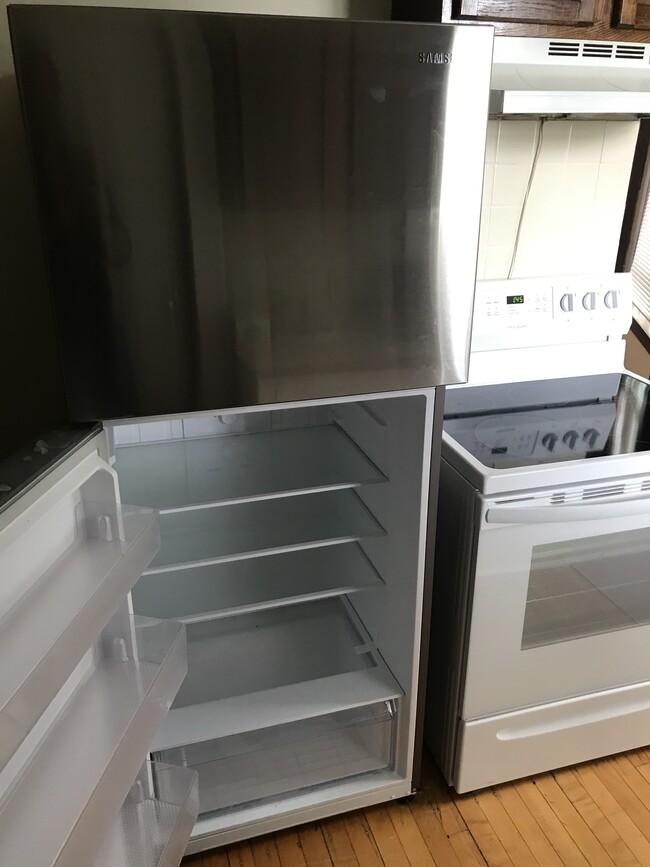 Stainless steel fridge and modern glass top stove - 1145 Jessie St