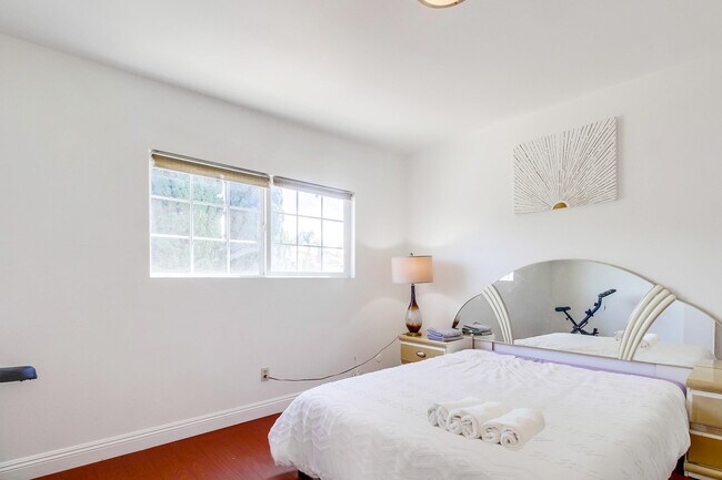 While, Bedroom 4 has a luxurious queen bed & an indoor exercise bike to keep you active - 2304 E 14th St