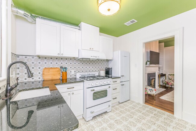 Kitchen with new cabinets, tile floors and backsplashes, and all new appliances. - 108 W Henry St