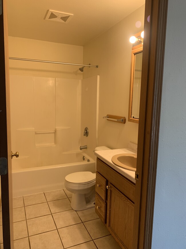 2 full baths feature tile flooring. - 1716 5th St E