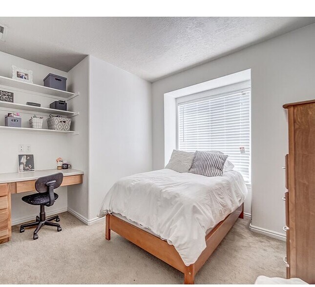 Bedroom Furnished with Bed, Dresser, Desk and Shelves - 543 N University Ave