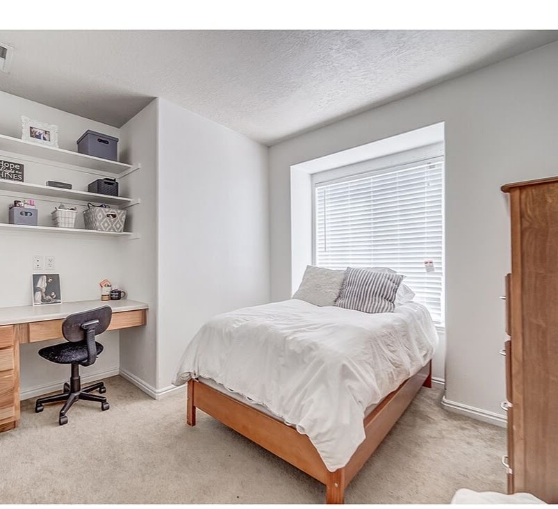 Bedroom Furnished with Bed, Dresser, Desk and Shelves - 543 N University Ave