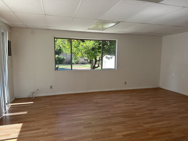 Studio interior, AC and heating, view of yard. - 5182 Woodley Ave