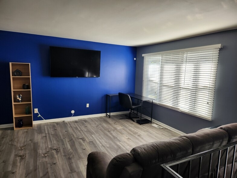 flat screen TV and desk in common shared area - 8917 Loughran Terrace