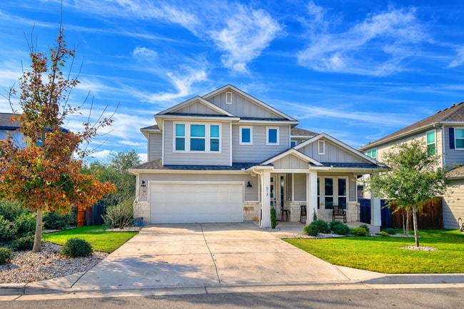 Beautiful two-story home with modern exterior, three-car garage, and inviting front porch. - 517 Moonlit Stream Pass
