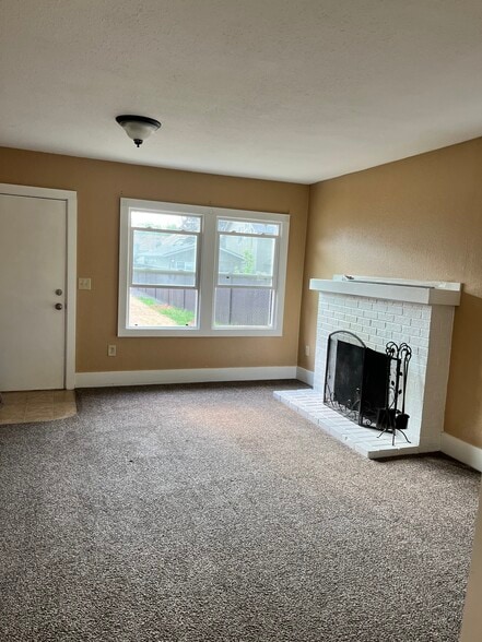 living room with wood burning fireplace - 441 16th St SE