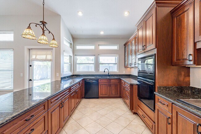 Building Photo - Charming 4-Bedroom Home with Luxurious Poo...
