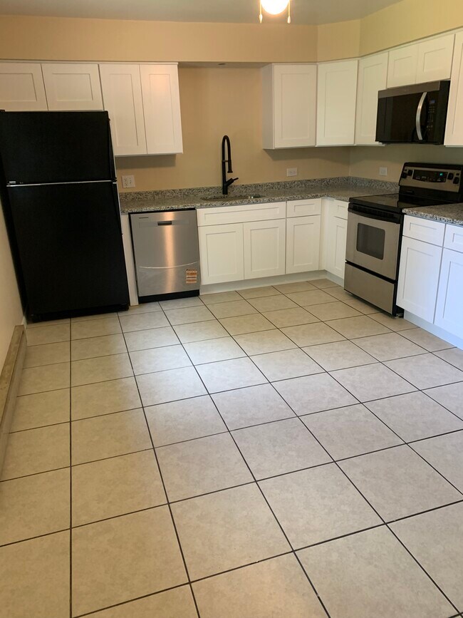 Renovated kitchen, dishwasher, built in microwave, black, and stainless appliances. Ceramic tile - 13918 Marybrook Dr