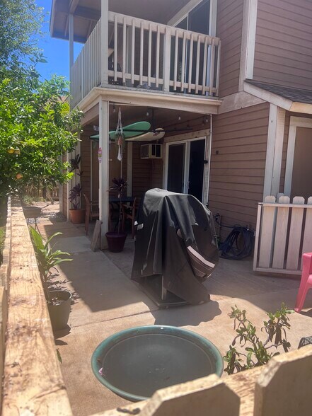 BBQ, large outdoor table and chairs, outdoor shower (behind pole), surf-board rack and storage - 140 Uwapo Rd