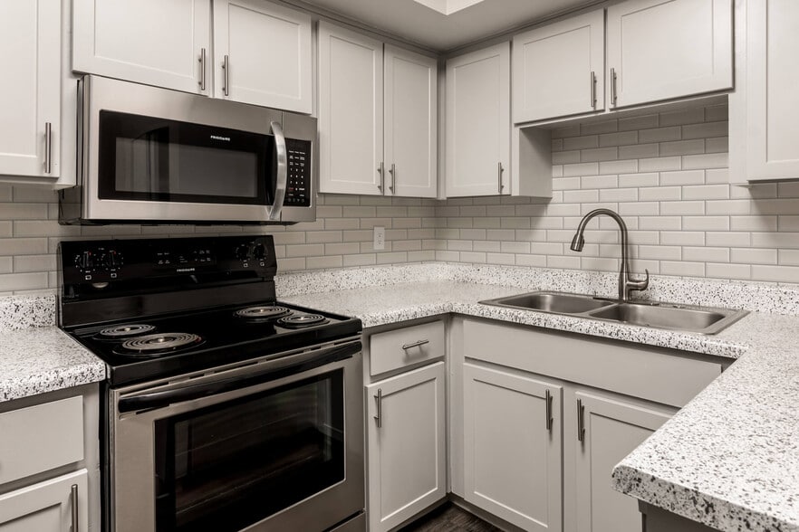 Kitchen with Subway Tile Backsplash and Modern Sink with Spray Faucet - Diamond Interior - Coral Point Apartments
