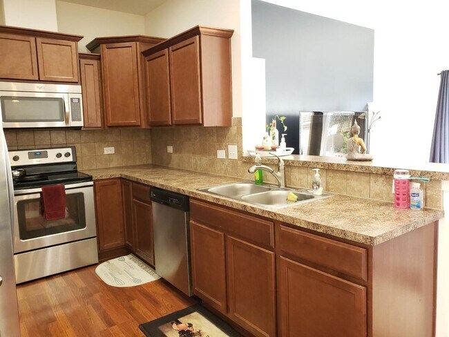 Galley kitchen with stainless steel applicances - 2527 Early Flight Dr