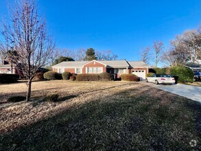 Building Photo - Lovely mid-sentry brick ranch on a beautif...