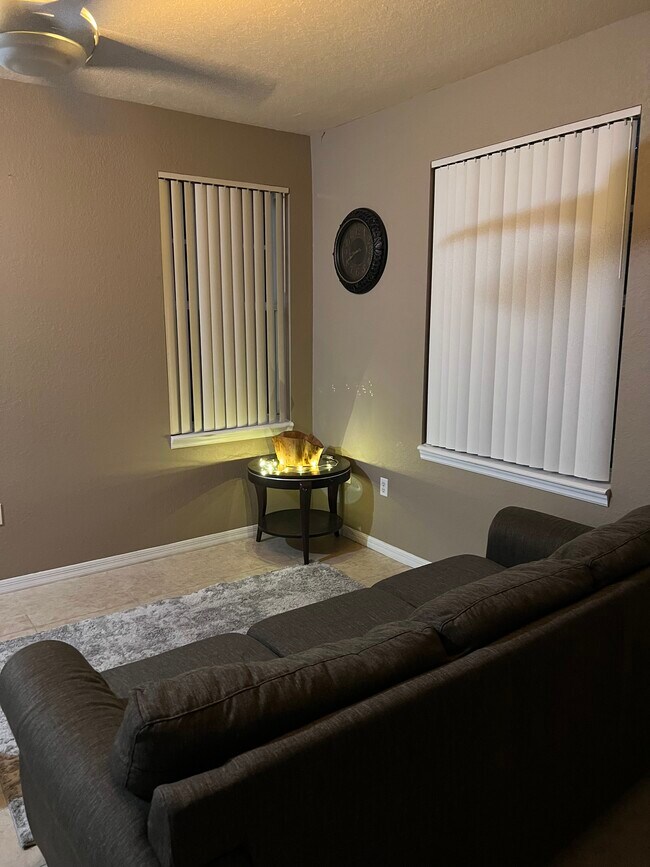 Living room furnished with sofa - 6832 W Sample Rd
