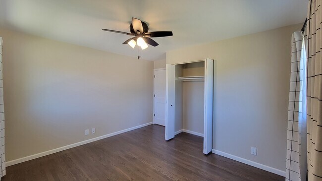 Bedroom 3. Refinished hardwood floors, 4 ft wide closet, new windows and ceiling fan. - 6305 49th Ave