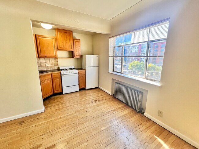Experience the charm of this cozy urban kitchen, with ample natural light and functional spaces. - Hillside Apartments