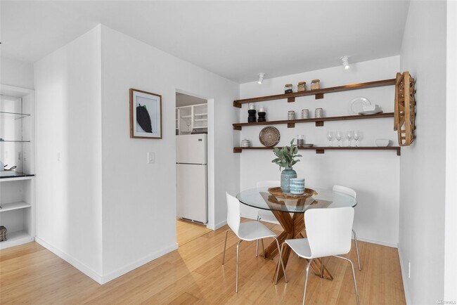 Dining nook with view of hallway and marble top mirrored bar - 730 Bellevue Ave E