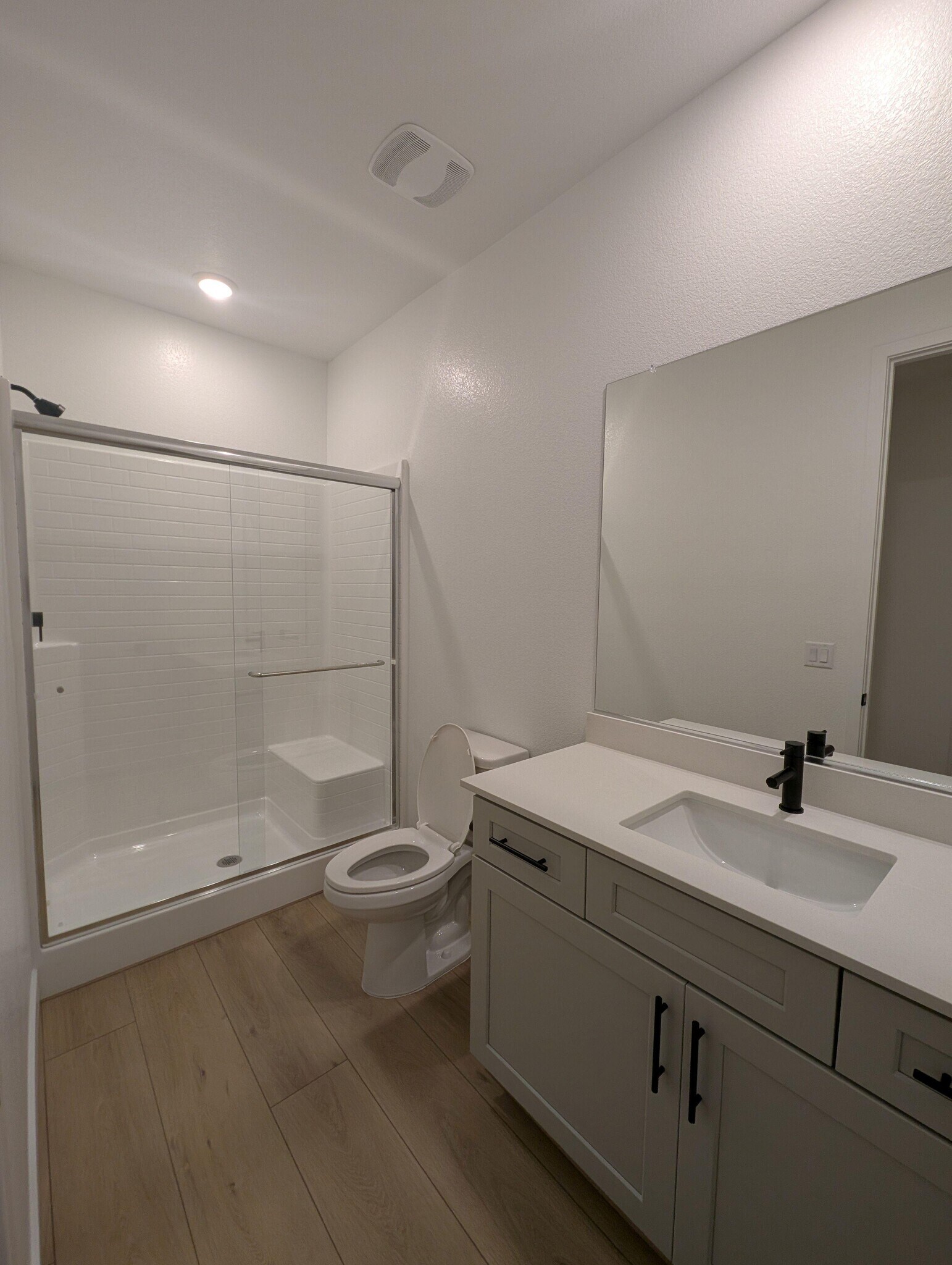 5' x 12' bathroom with walk-in shower, shower bench, toilet, and vanity - 628 S Cecita Wy