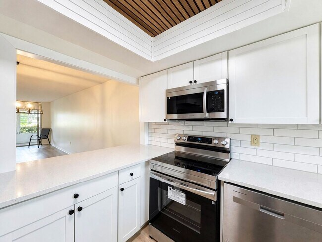Building Photo - AVAILABLE NOW! Beautifully Renovated First-Floor Condo with Peaceful Screened Lanai