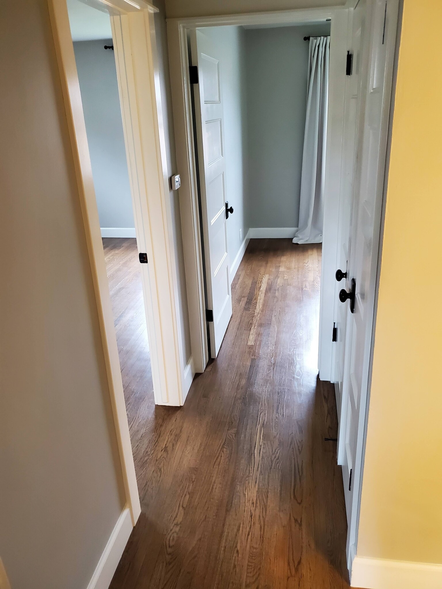 hallway from front bedroom2. 1 storage closet, one is AC - 8608 Harrison Way