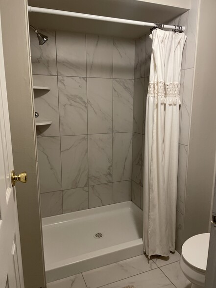 Master bath shower with curtain open - 127 Leedom Way