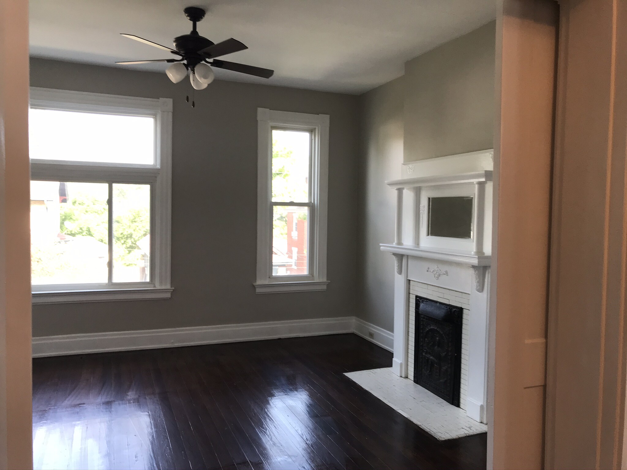 Bedroom with fireplace, fan and lots of windows. - 2221 Oakland Ave