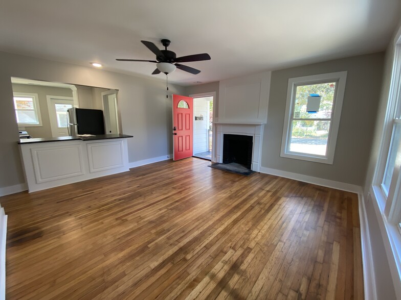 Spacious open concept living area, refinished original hardwoods, ceiling fans neutral palette - 1524 Ward Ave NE