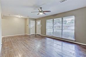 Living/dining combination. Notice the charming front door and coat closet. - 4609 Nina Lee Ln