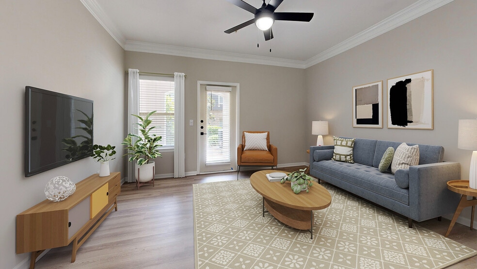Large living room with hardwood style flooring and patio. - Waterstone at Big Creek Apartments