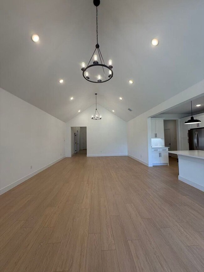 Building Photo - Move-in ready and like-new! Washer, dryer, and refrigerator Included.