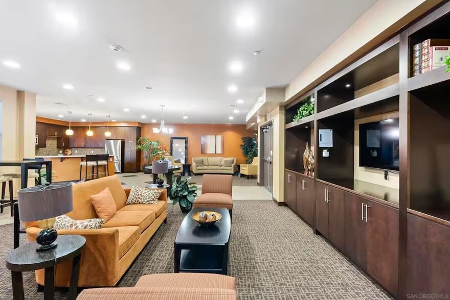 Spacious community lounge with seating & work-friendly space. - 3687 4th Ave