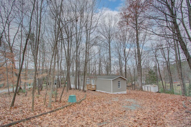 Building Photo - Nestled on a spacious, private wooded wate...