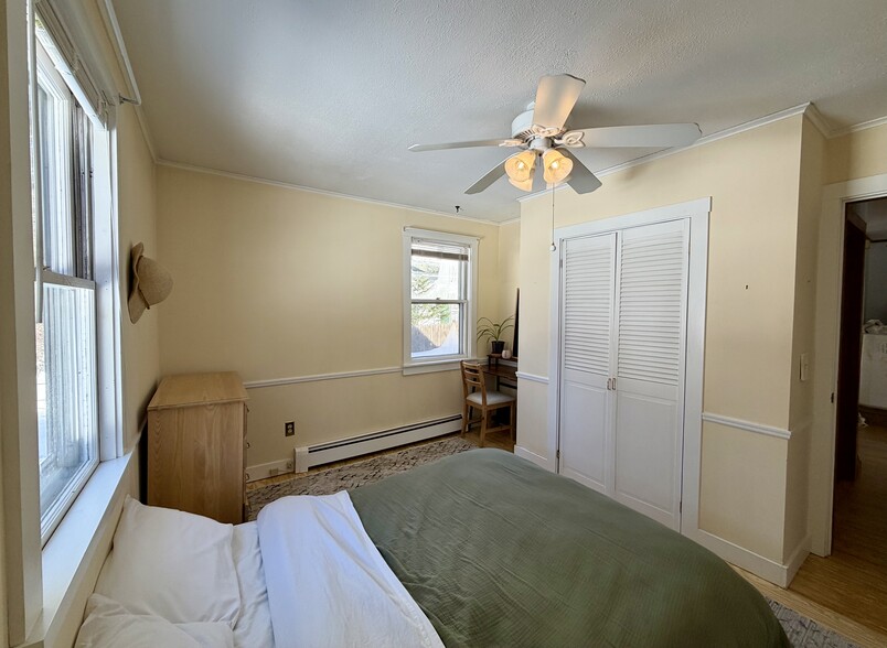 main floor bedroom with queen bed, dresser, and desk - 34 Boody St