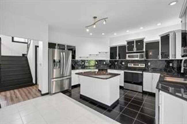 Building Photo - Spacious 5-Bed Walkout Home with Over 3,50...