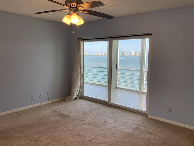 Master bedroom waterfront view with slider to balcony - 501 Lake Shore Dr