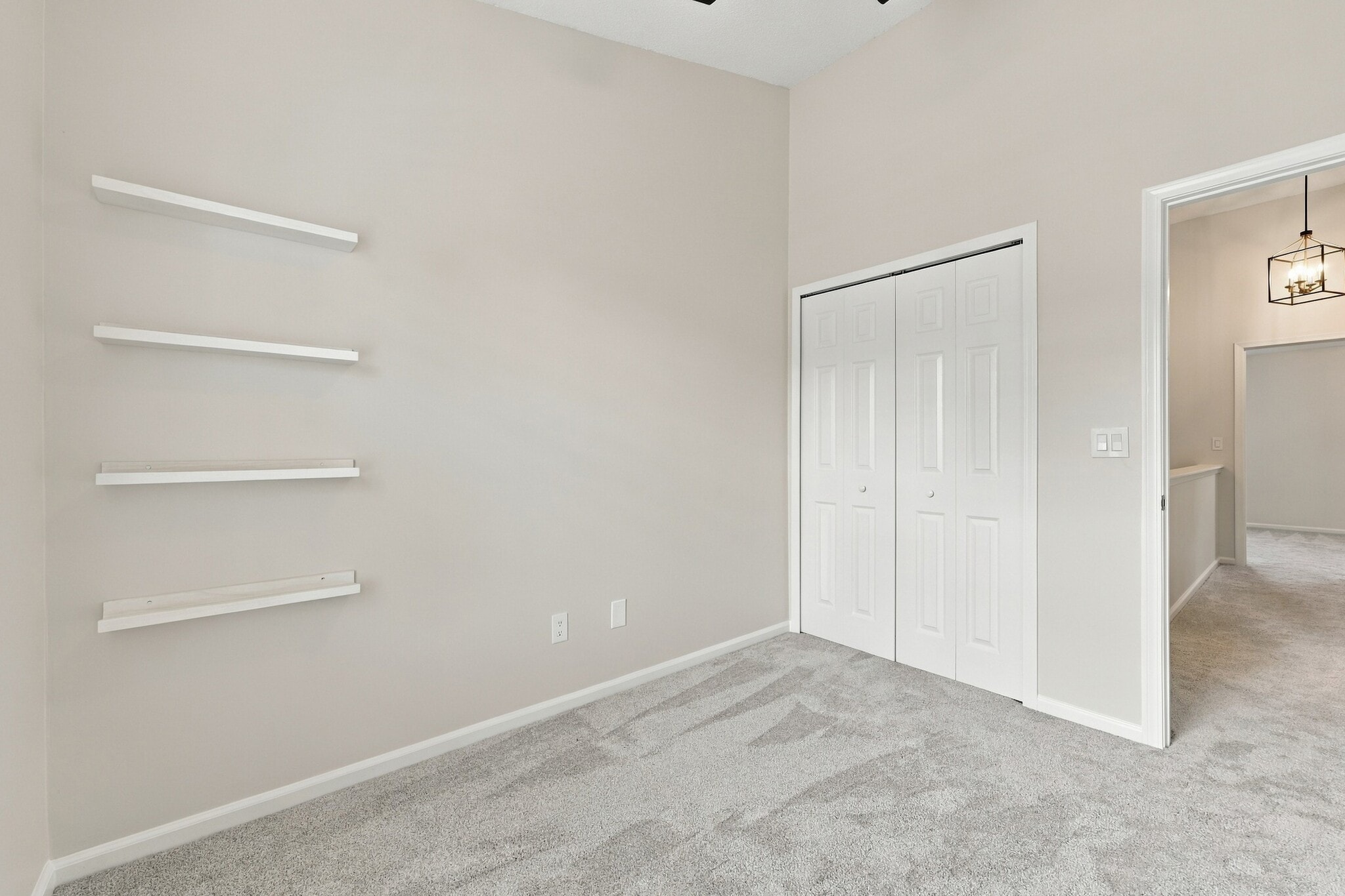 Bright secondary bedroom with vaulted ceiling and natural light. - 3622 Caroline Vale Blvd