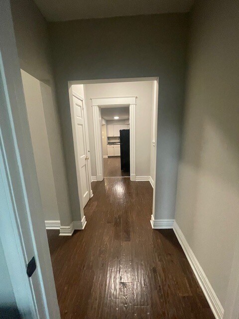 view from bathroom to kitchen - hall has access to basement and storage closet - 1515 Holman Ave
