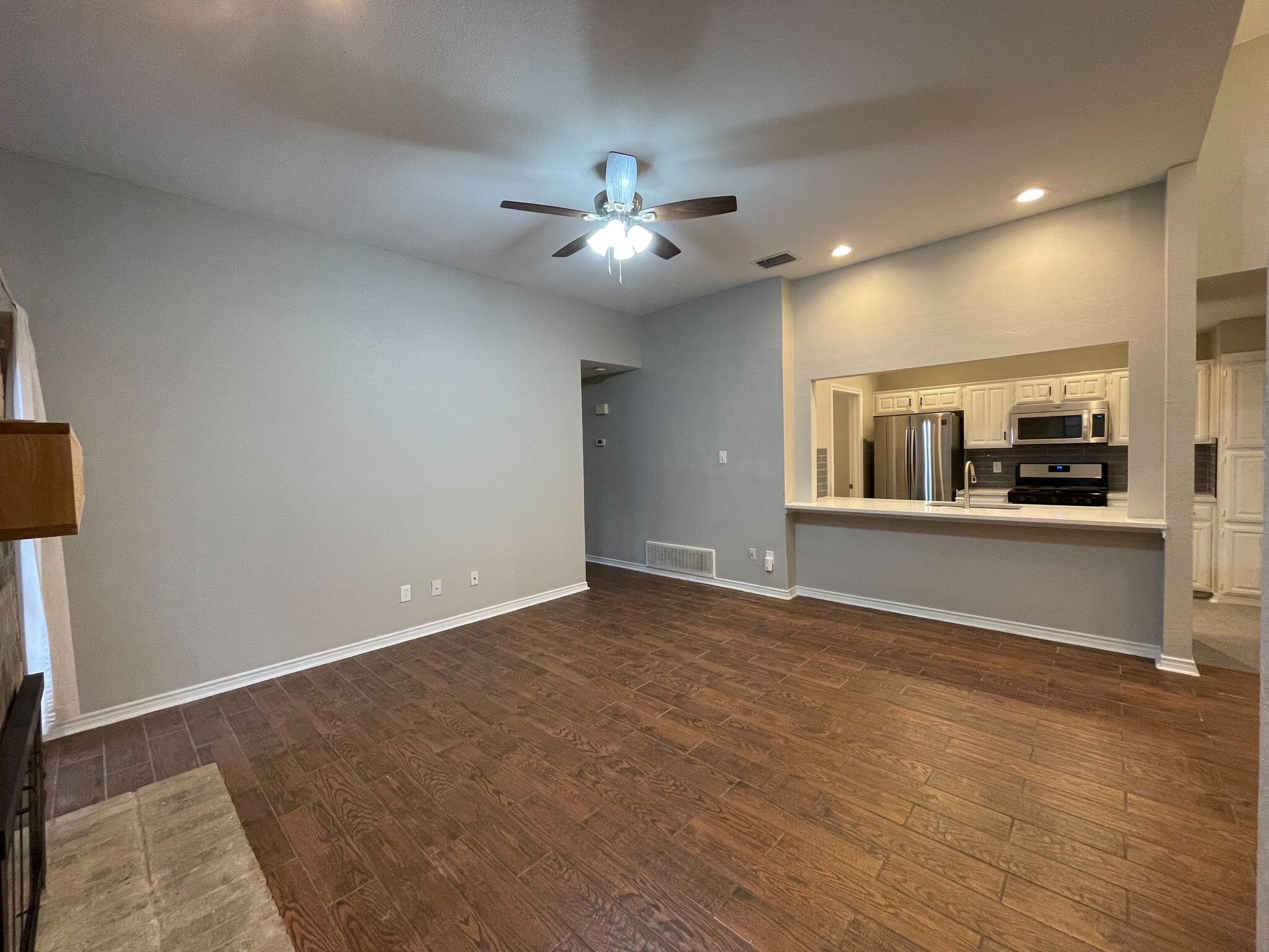 Open concept Kitchen, dining and living room. Features wood look tile throughout the home. scrapped ceilings, fresh interior paint, gas logs in the fire place and all new ceiling fans and light fixtures throughout. - 812 Via Madonna