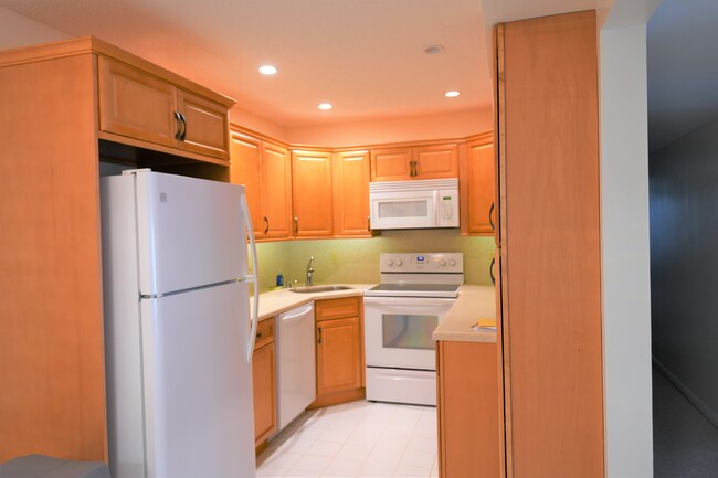 Updated kitchen with Corian countertops and maple cabinets. - 1935 Silver Pine SW Way