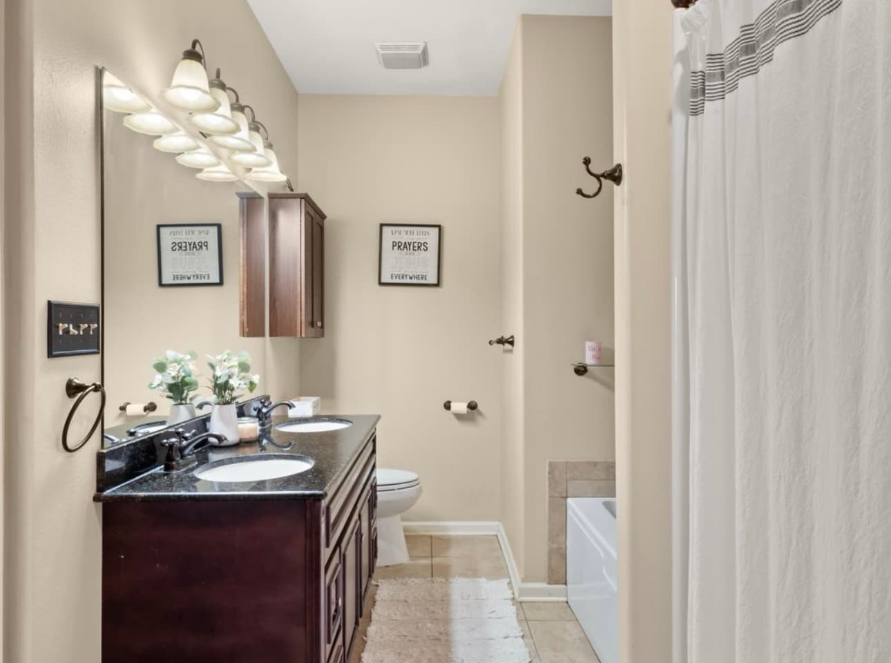 Master bathroom with double vanity, bathtub, shower, and walk in closet - 1708 Brookhaven St