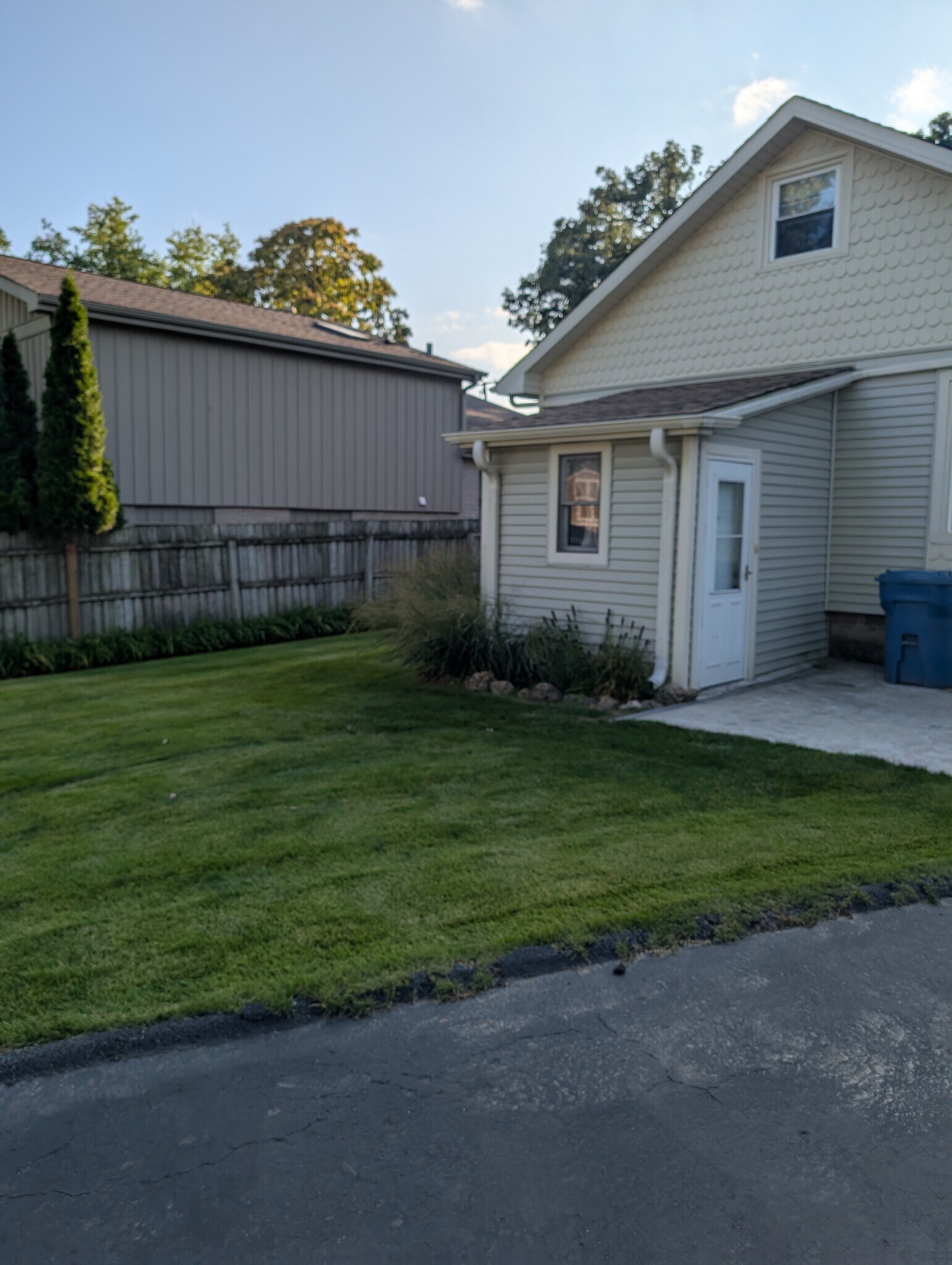 Back yard and patio. Back entrance into mudroom. - 14837 Keating Ave