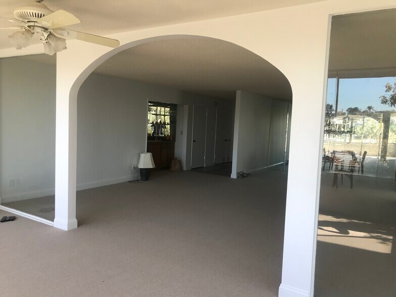 From sunroom to main entrance, wet bar, closet off front door - 8701 Delgany Ave
