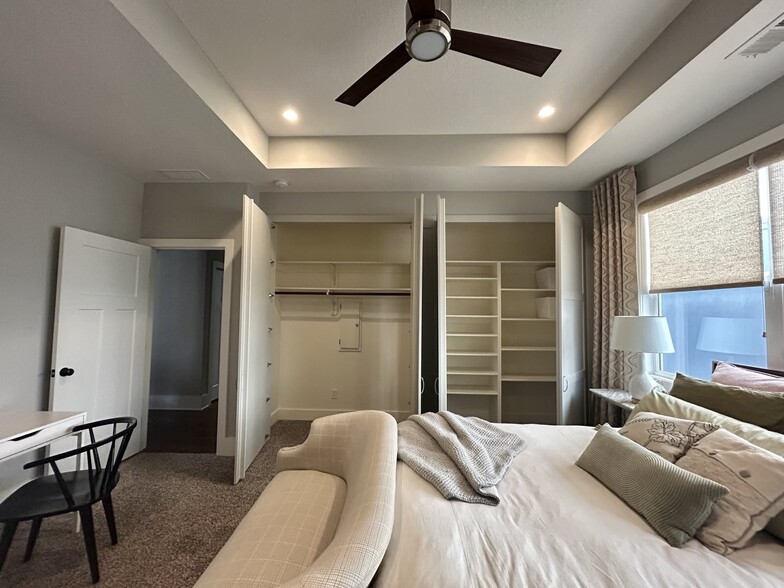 Primary bedroom with ensuite bathroom and separate his and her closets - 405 E 32nd Ave