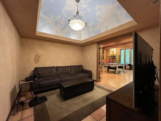 Building Photo - One-of-a-Kind Custom Home with Wall of Windows, Stone Fireplaces, Expansive Entertainment Space &...