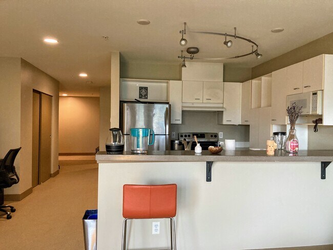 Open kitchen with bar seating - 2440 Western Ave