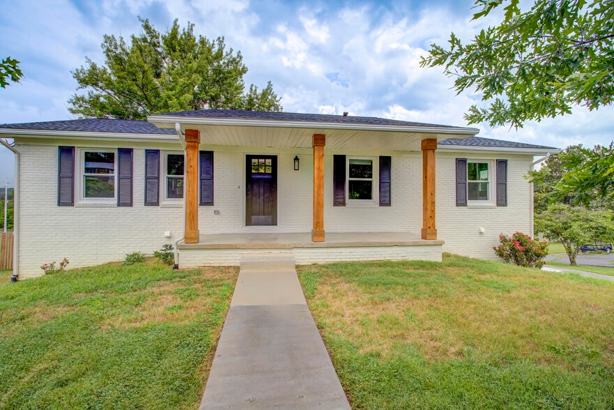 Front of house with new painted brick, new shutters, and new posts - 288 Beaver Rd