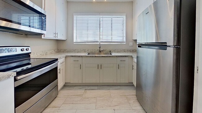 Building Photo - Riverfront Living! First Floor Unit w/ Private Patio, Stunning Views & Upgraded Kitchen